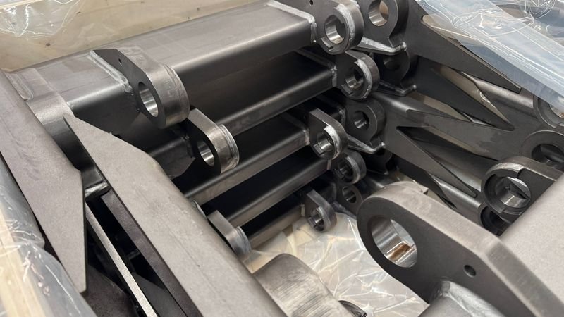 Steel arms with bored lug ends, wrapped and crated