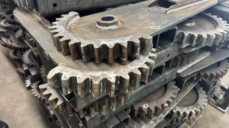 Stacked welded steel frames with sprockets